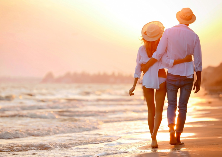Romantic couple walking on beach