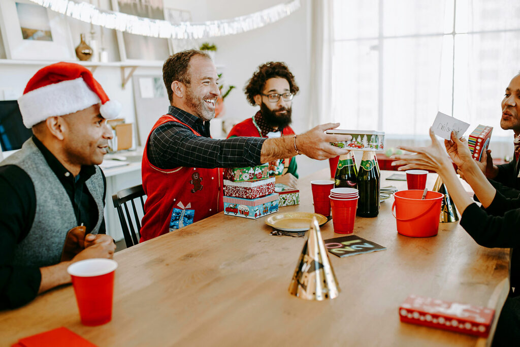 Employees exchanging Secret Santa gifts